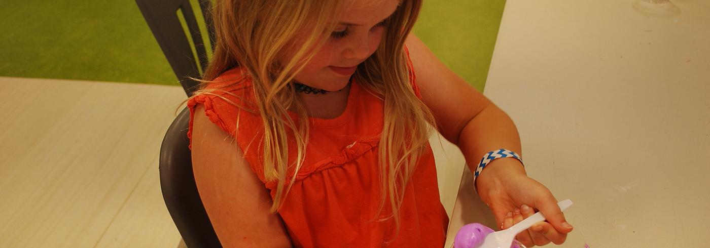 Child engaging with an interactive educational activity at CMC